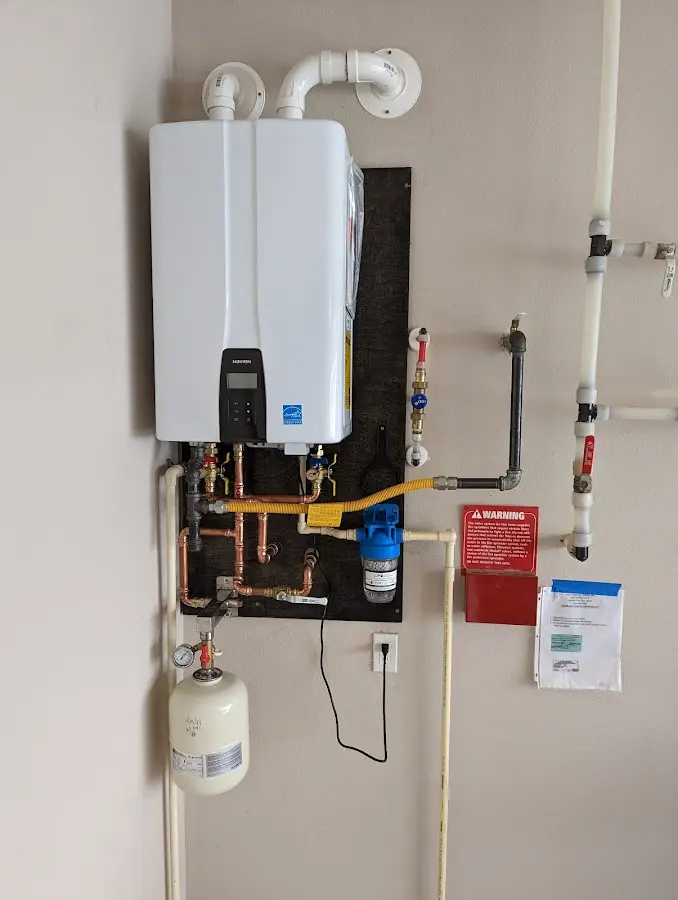 Professional plumber installing copper piping in a Coxsackie home